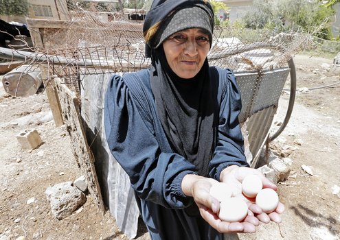 Old woman with eggs in her hand.